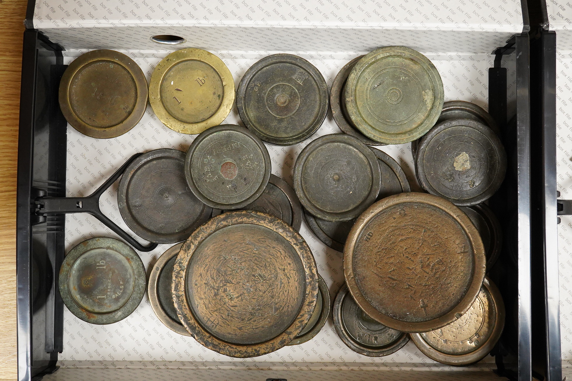 A collection of mainly 18th and 19th century bronze imperial circular trade weights and bell weights, stamped with Royal Cyphers, weights, the dagger assay mark for London, other proof marks, etc., contained within two b